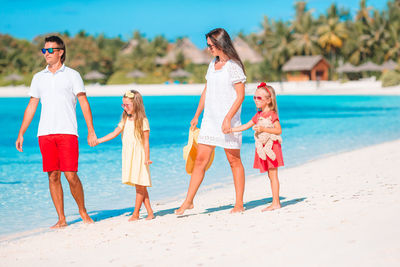 Full length of family walking on beach