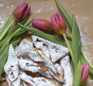 Close-up of tulips and food on table