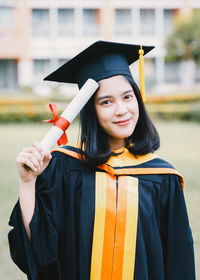 Portrait of smiling young woman standing outdoors