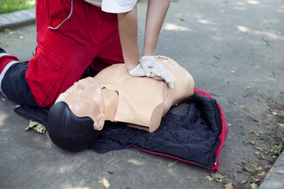 Low section of woman applying cpr on dummy