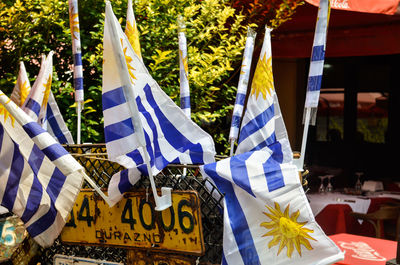 Low angle view of flags hanging against trees