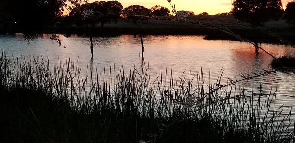 Scenic view of lake against sky during sunset