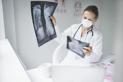 Close-up of doctor examining medical x-ray at clinic