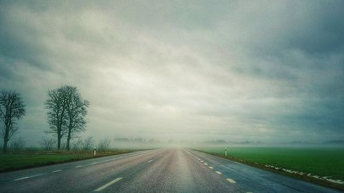 Road by landscape against sky