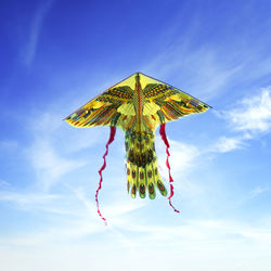 Low angle view of kite flying against sky