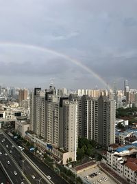High angle view of rainbow over city buildings