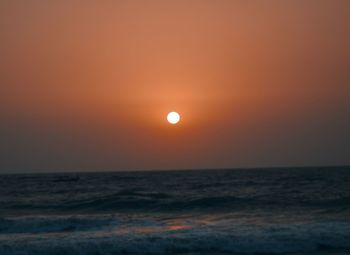 Scenic view of sea against orange sky