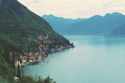 Scenic view of sea and mountains against sky