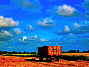 Built structure on field against blue sky