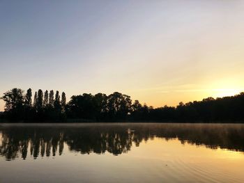 Scenic view of lake against sky during sunset