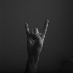 Close-up of human hand against black background