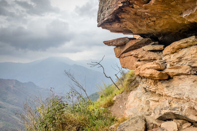 Scenic view of mountain against cloudy sky