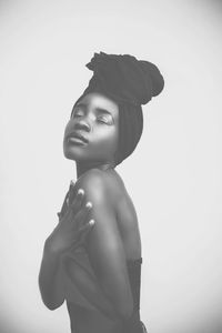 Side view of young woman against white background