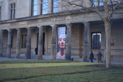 Portrait of woman standing in front of built structure