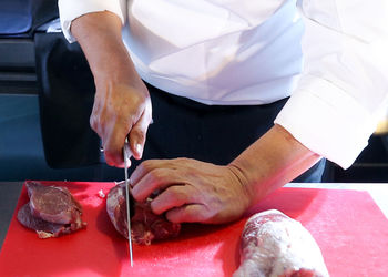 Midsection of man working in tray