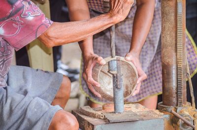 Low section of people working on metal