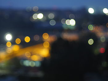 Defocused image of illuminated city at night