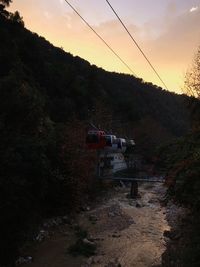 View of overhead cable car on road against sky