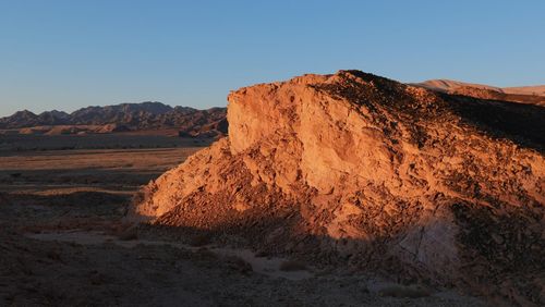 Scenic view of arid desert against clear sky