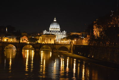 Tiber river by st peter basilica at night
