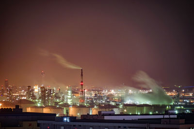 Smoke emitting from factory against sky at night