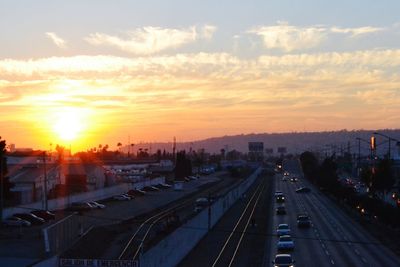 Cars on road at sunset