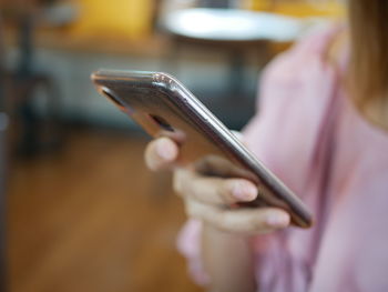 Midsection of woman using mobile phone