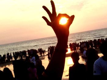 Silhouette people at beach during sunset