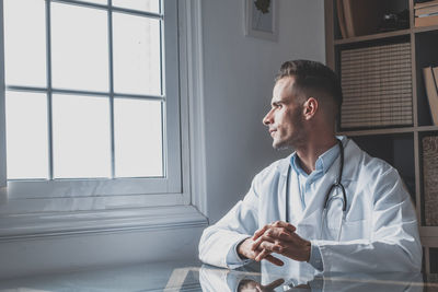 Man looking through window