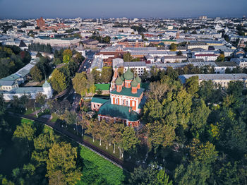 High angle view of trees and buildings in city