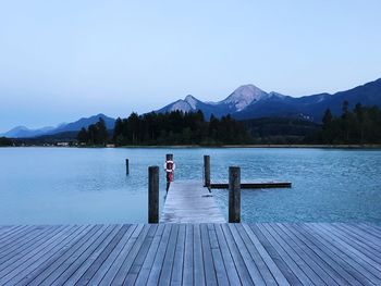 Scenic view of lake and mountains against clear sky