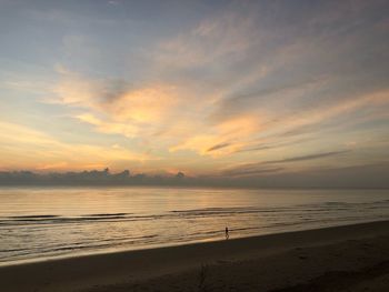 Scenic view of beach against sky during sunset