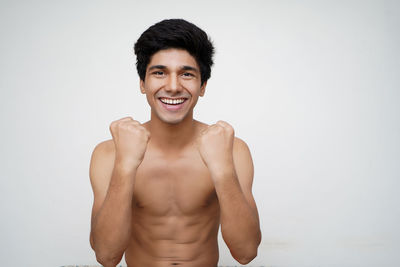 Portrait of a smiling young man against white background