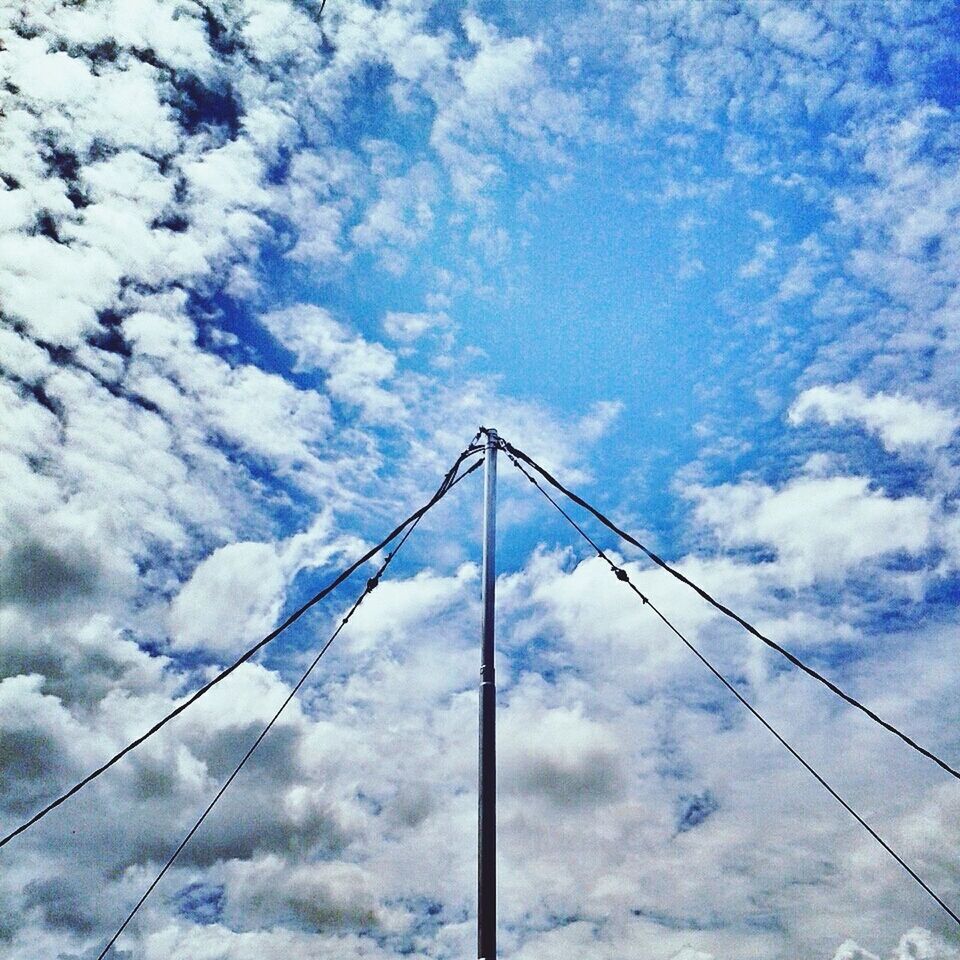 low angle view, sky, cloud - sky, cloudy, cloud, connection, electricity, blue, power line, day, power supply, metal, cable, outdoors, no people, fuel and power generation, weather, pattern, electricity pylon, built structure