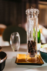 Close-up of pepper mill on table