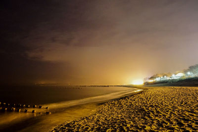 Scenic view of beach against sky during sunset