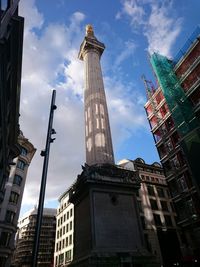 Low angle view of building against cloudy sky