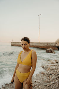 A girl on the beach with a yellow bikini