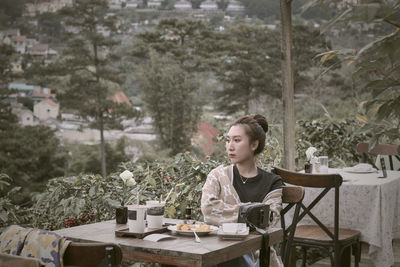 Portrait of smiling young woman sitting on chair