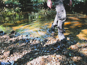 Low section of a man walking in shallow water