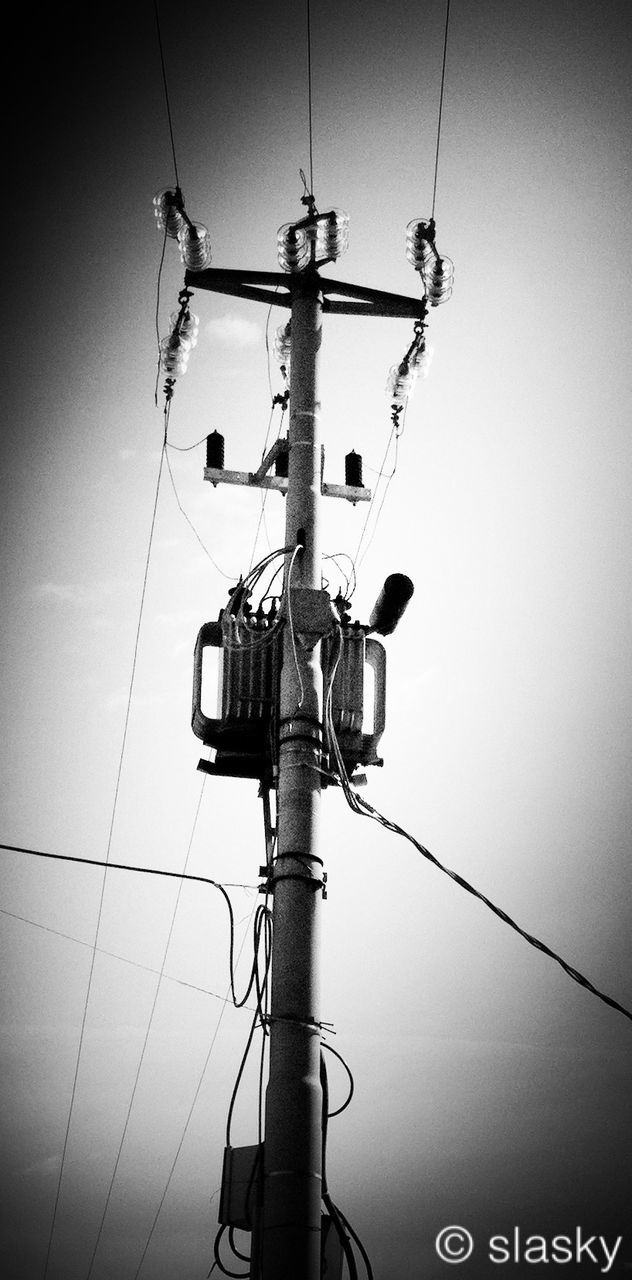 low angle view, electricity, power line, technology, power supply, cable, fuel and power generation, lighting equipment, connection, electricity pylon, street light, pole, sky, communication, hanging, day, clear sky, no people, power cable, outdoors