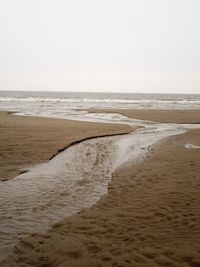 Scenic view of beach against clear sky