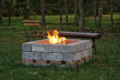 Bonfire on wooden structure in field