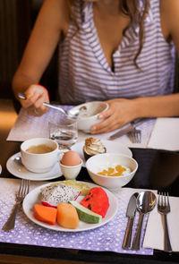 Midsection of woman eating food