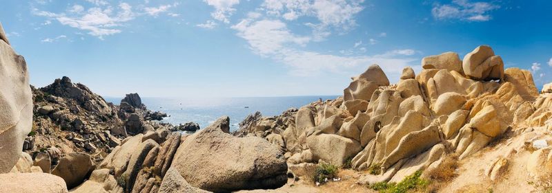 Panoramic view of rocks on beach against sky