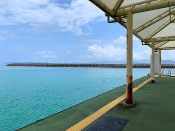 Scenic view of swimming pool by sea against sky