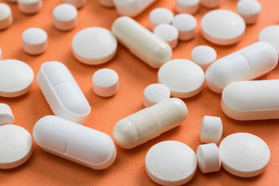 Close-up of medicines over colored background