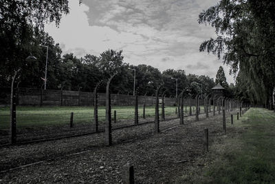 Wooden fence on field against sky