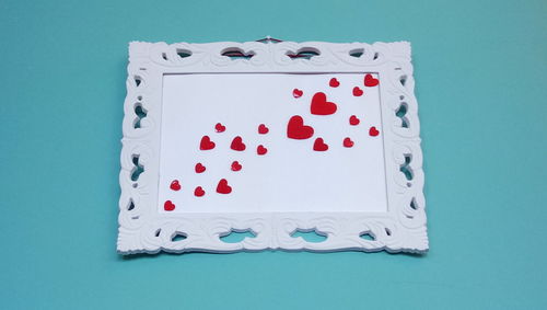 High angle view of heart shape on table against blue background