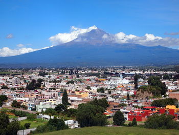 Town by mountains against sky